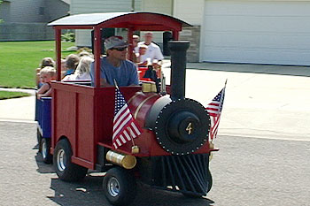 Families watching the Choo Choo Express trackless train at a corporate event
